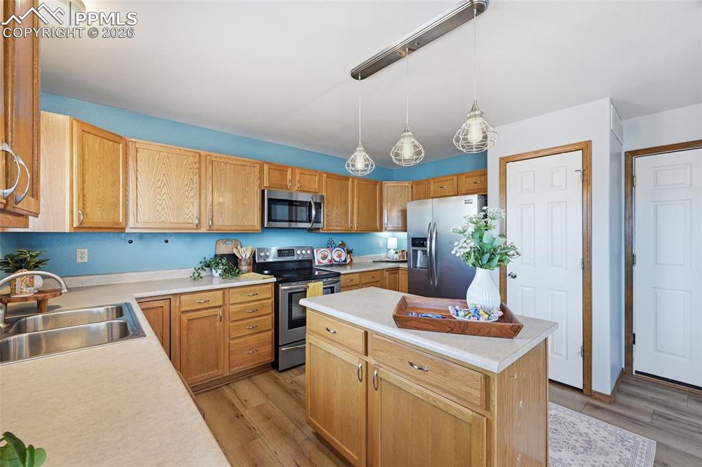 Image 12 of 42: Pantry closet and island offering more counterspace