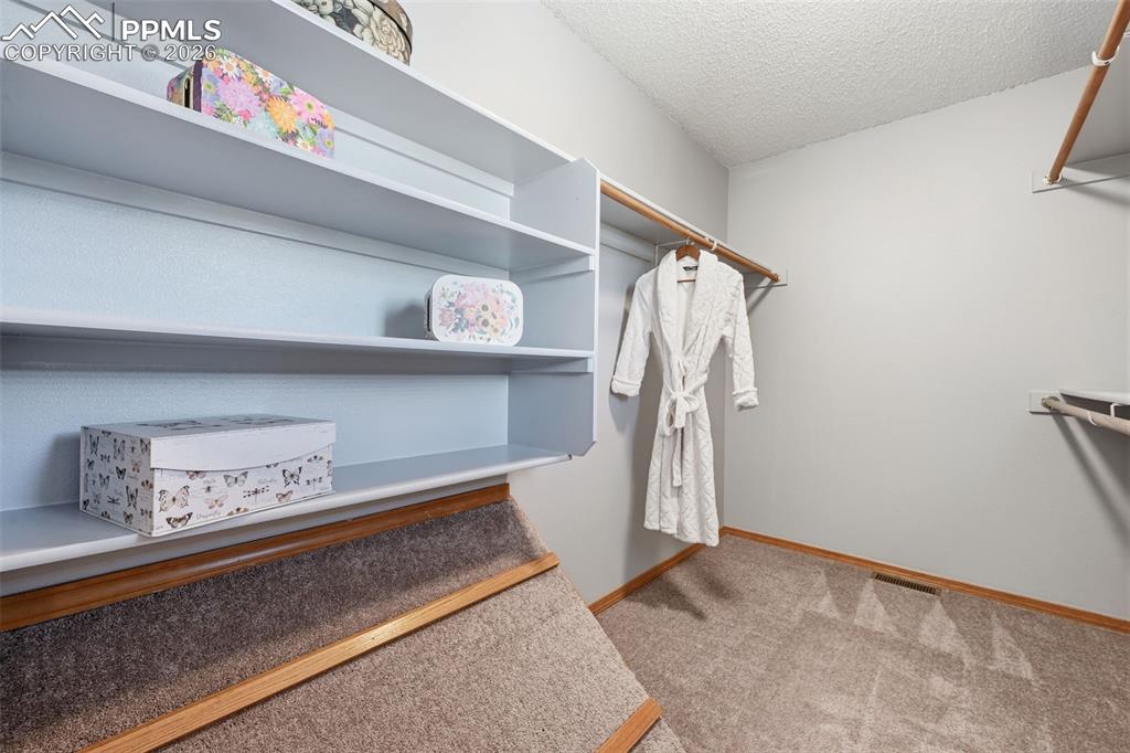 Image 17 of 42: Primary bedroom walk in closet