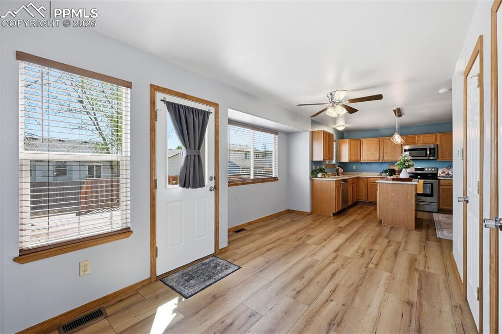 Image 7 of 42: Dining area with door to deck and backyard