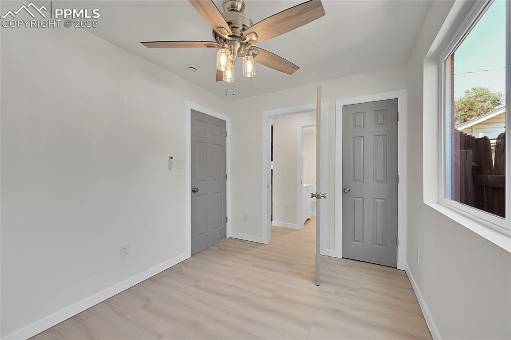 Image 16 of 30: Unfurnished bedroom with light wood finished floors and ceiling fan