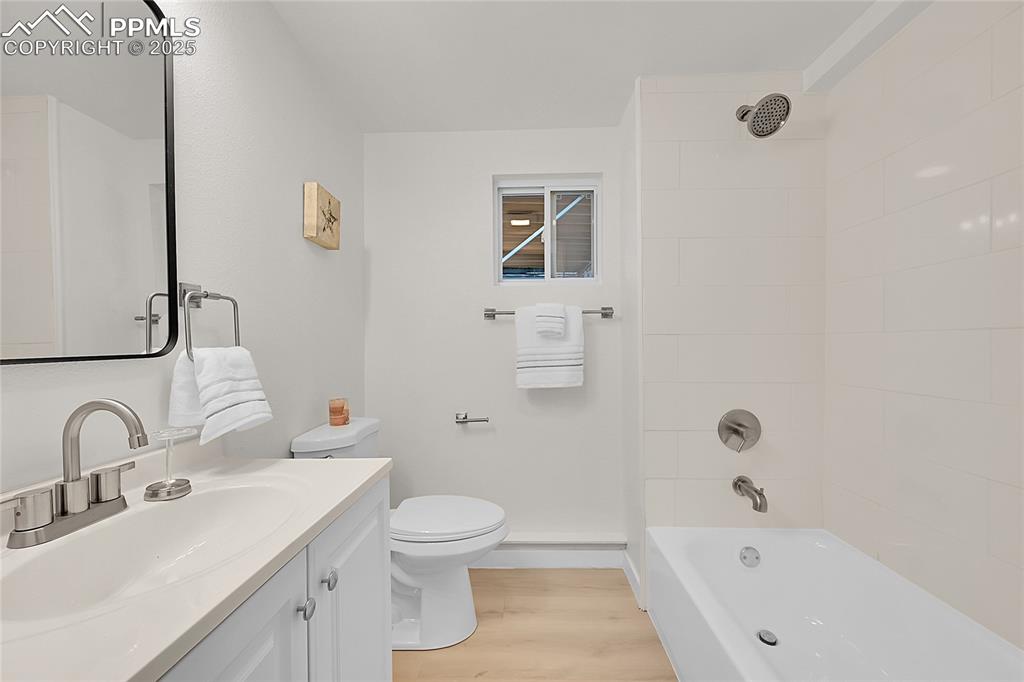 Image 17 of 30: Full bathroom featuring bathtub / shower combination, light wood-style floo