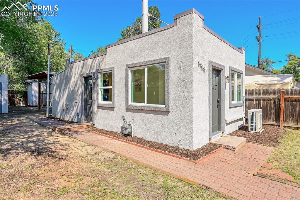 Image 22 of 30: Side of house featuring stucco siding