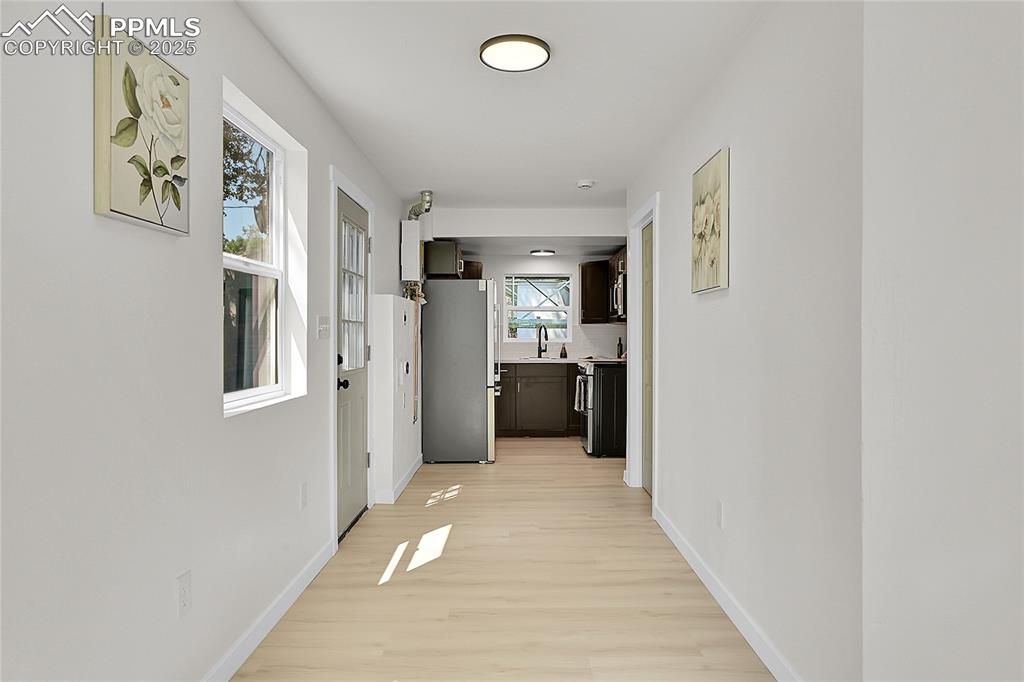 Image 3 of 30: Hall featuring baseboards and light wood-style flooring