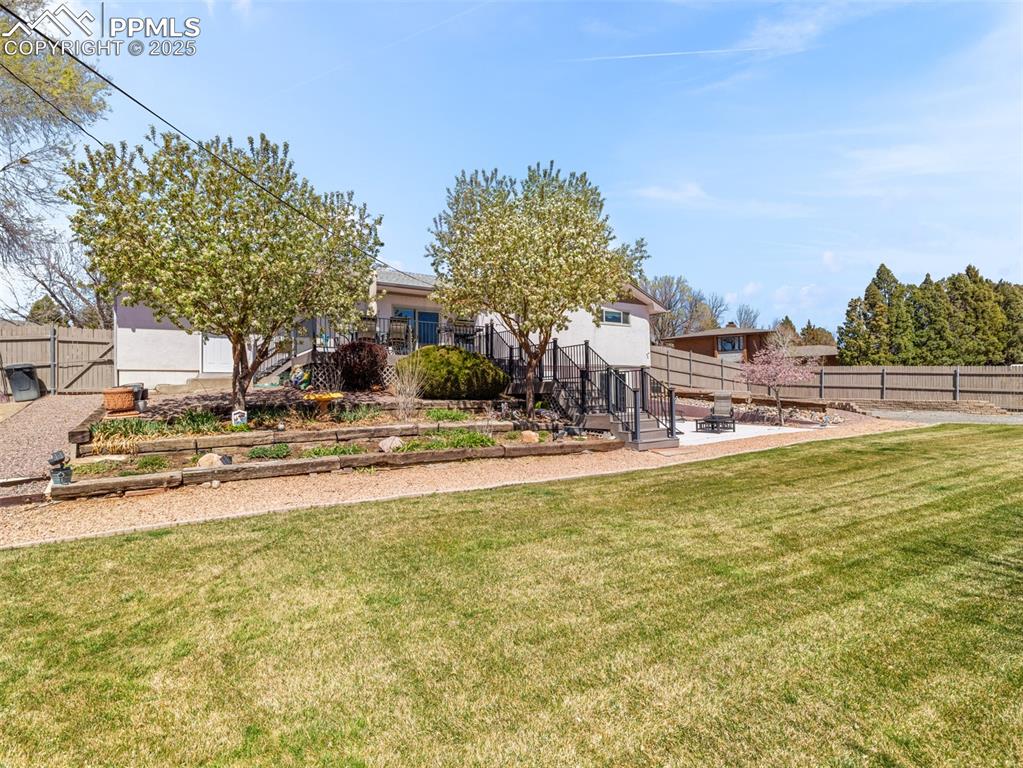 Image 34 of 41: Fenced backyard featuring a gate