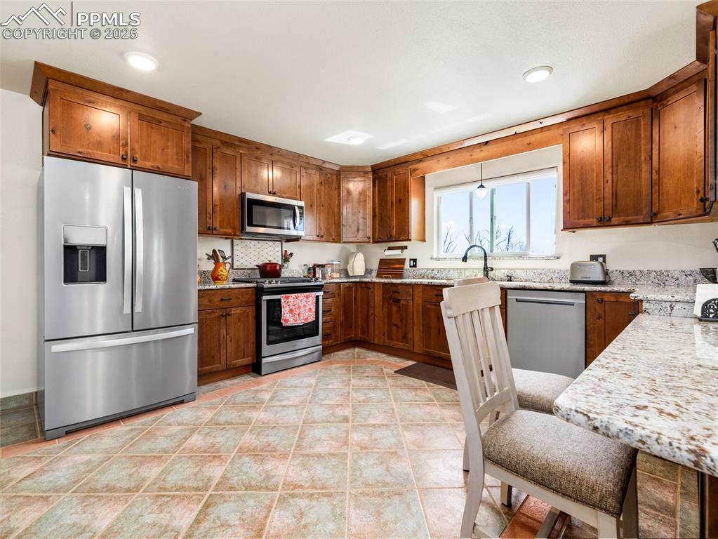 Image 6 of 41: Upgraded kitchen with appliances with stainless steel finishes, beautiful g