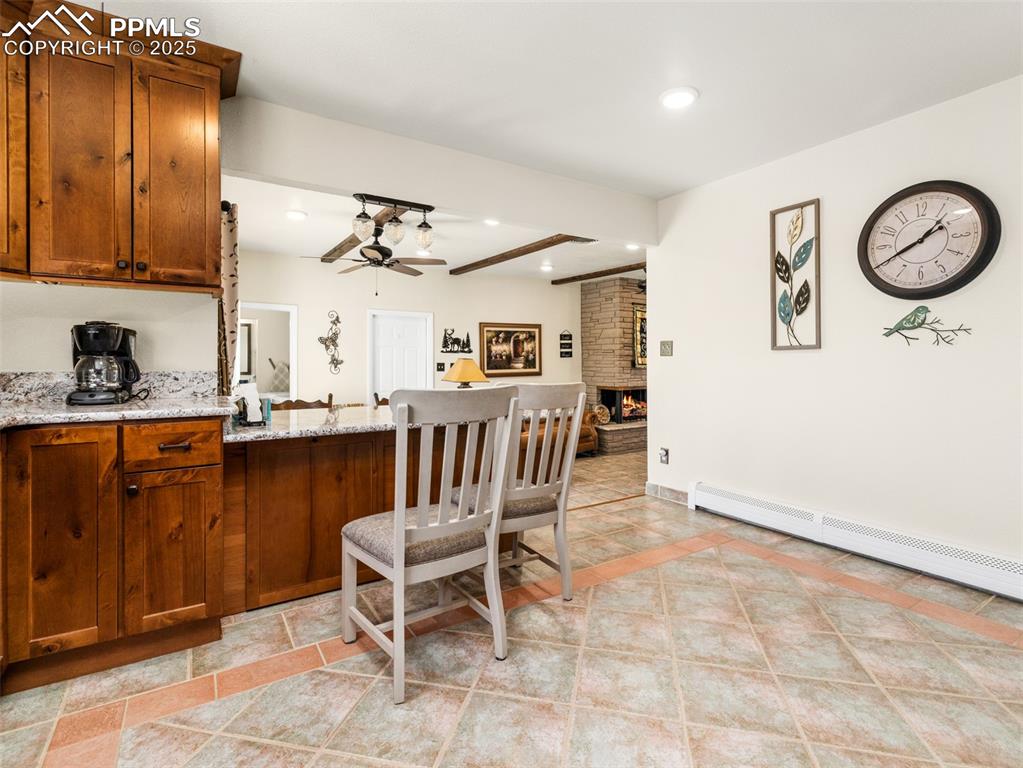 Image 7 of 41: Kitchen featuring a kitchen bar, beautiful granite countertops, recessed li