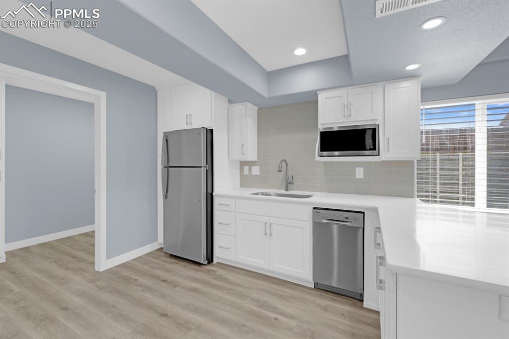 Image 21 of 40: Basement Kitchenette featuring stainless steel appliances and Quartz Counte