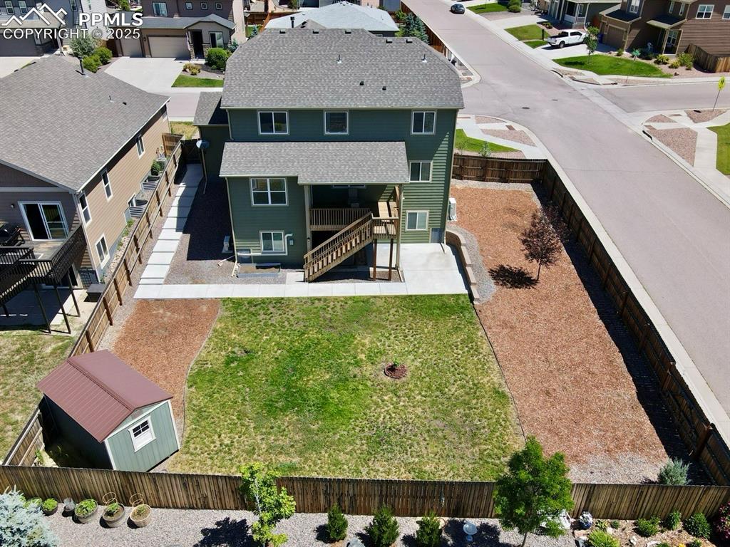 Image 35 of 40: Aerial perspective of back yard and covered deck/patio