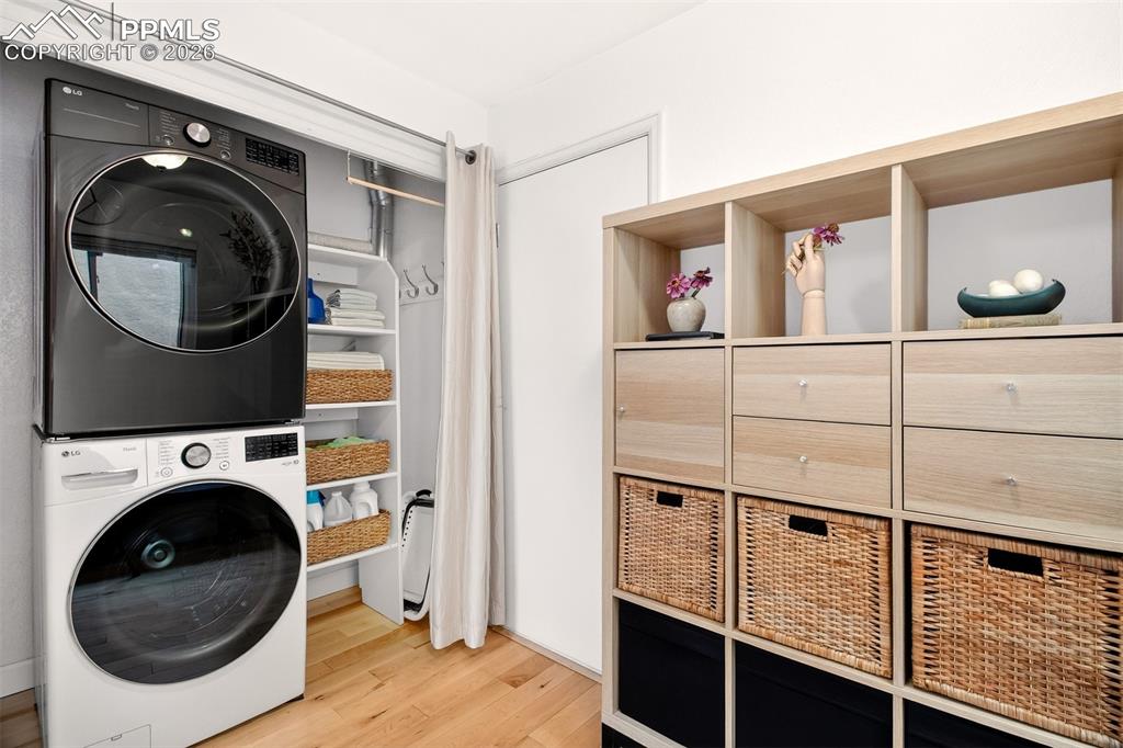 Image 13 of 36: Laundry area with additional shelving.