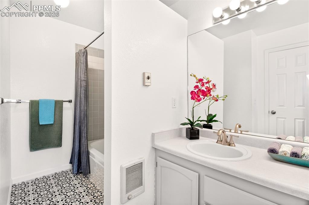 Image 17 of 32: Primary ensuite with newly painted cabinets and new flooring.