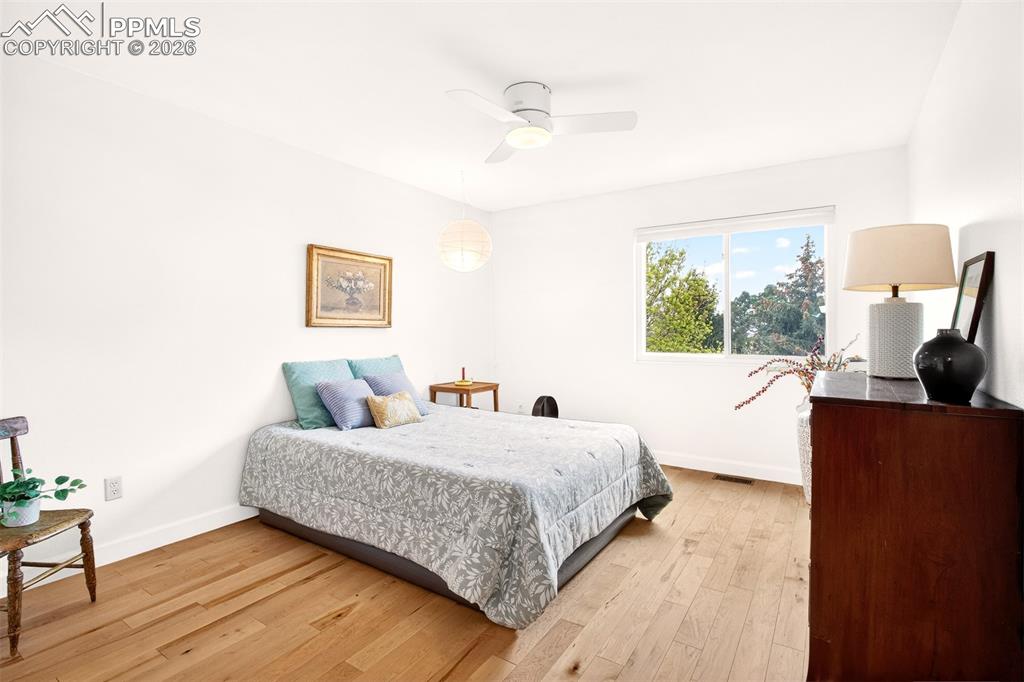 Image 20 of 36: Upstairs second bedroom offers charming views from its window.