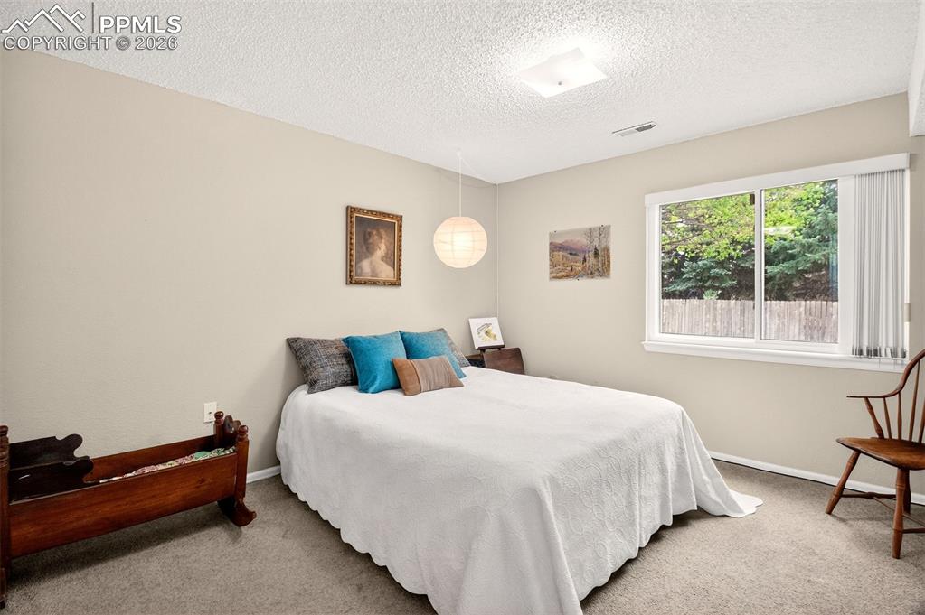 Image 26 of 36: Oversized basement bedroom, ideal for guests or a home office.