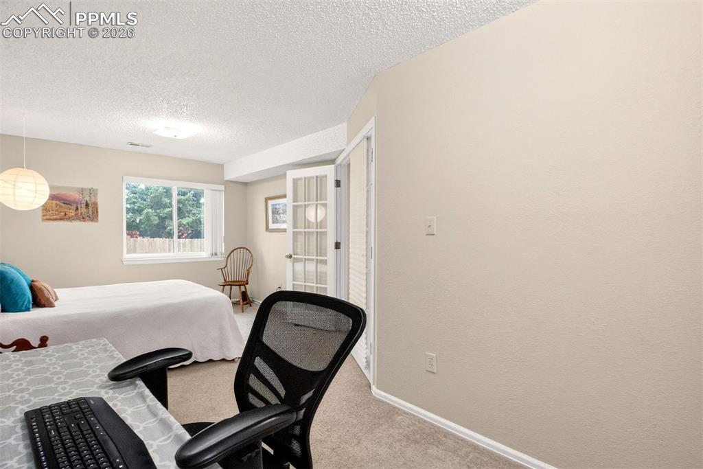 Image 28 of 32: Versatile bedroom with enough room for a work or study area.