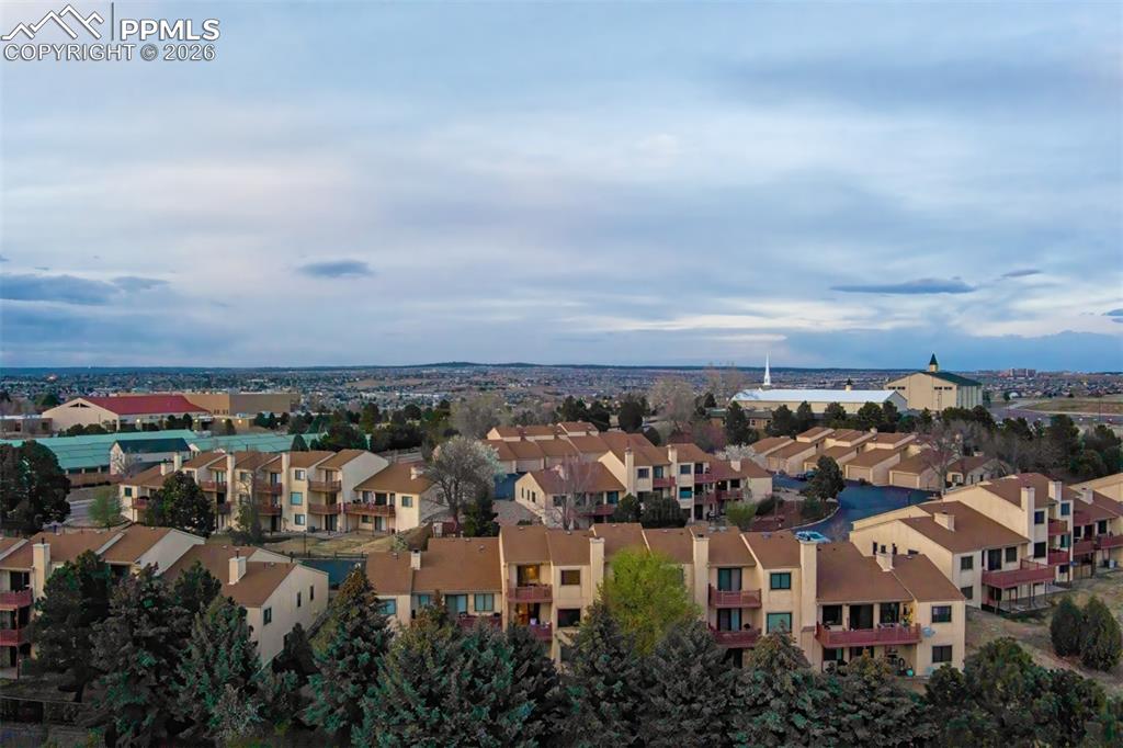 Image 30 of 32: View from above showing the complex and surrounding fir trees.
