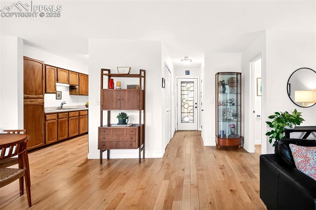 Image 4 of 36: Entryway with a beautiful rainfall glass front door and new 30 year enginee