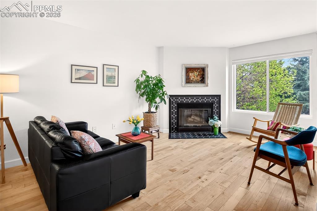 Image 5 of 36: Living area featuring a new tile fireplace, large picture window and those