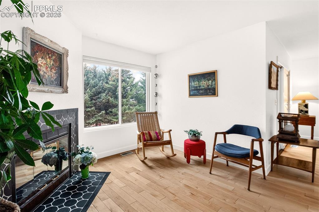Image 6 of 32: Another view of the living room and beautiful fir trees.