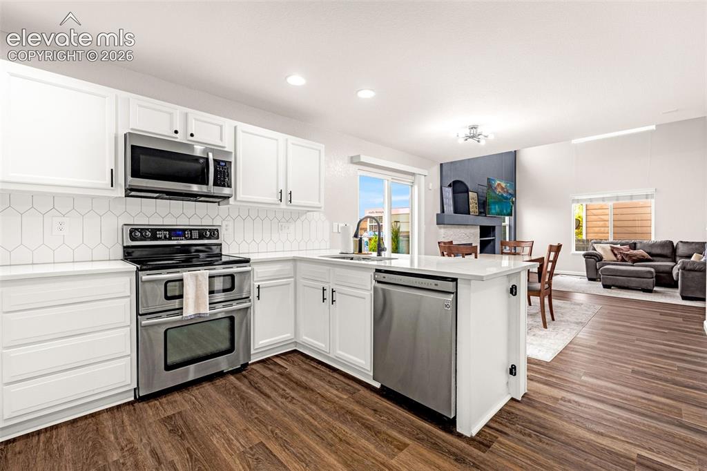 Image 12 of 35: Kitchen featuring white shaker-style cabinetry, stainless steel appliances,