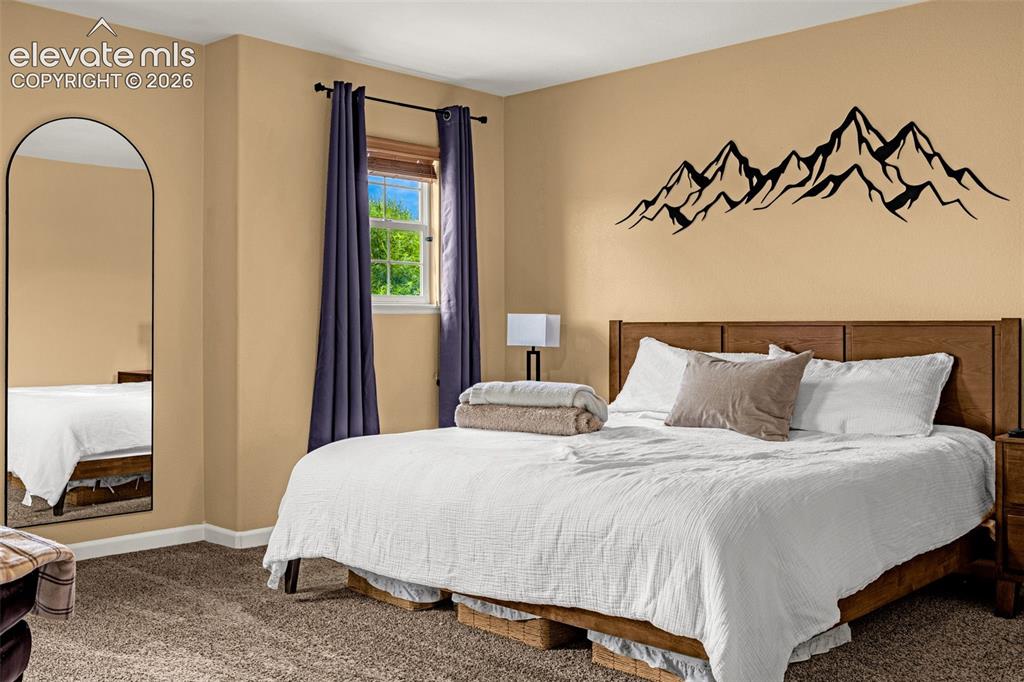 Image 17 of 35: Neutral-toned room featuring wall-to-wall carpeting, a multi-pane window wi