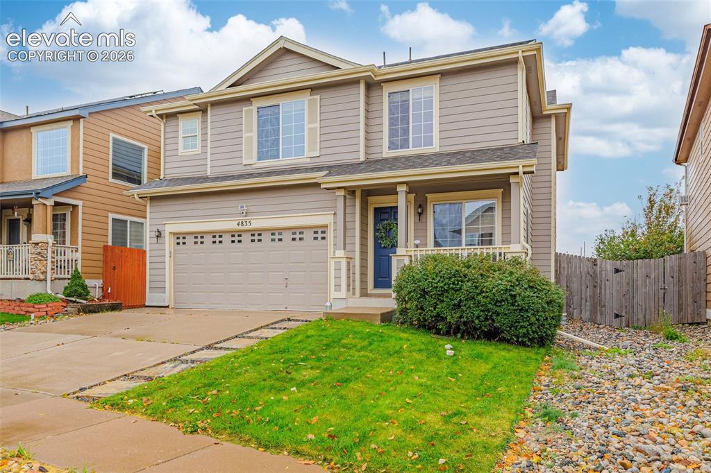 Image 34 of 35: Two-story residence featuring horizontal lap siding, a front-facing attache