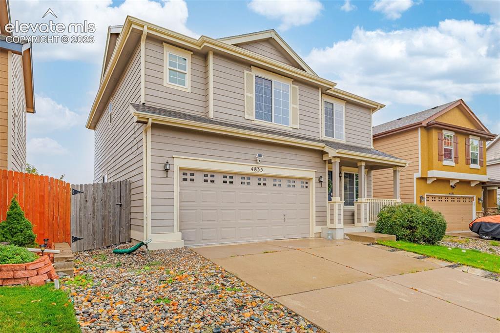 Image 35 of 35: Two-story residence featuring horizontal siding, a covered front porch with