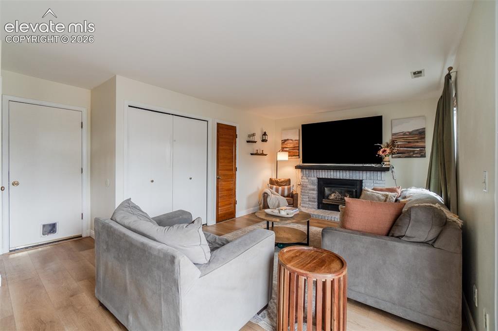 Image 11 of 31: Wood-finish flooring, white painted walls, white double closet doors, white