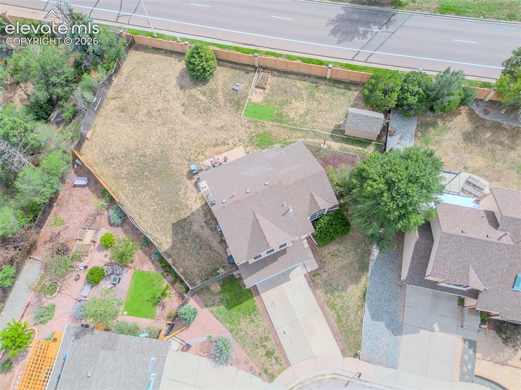 Image 26 of 31: Expansive property featuring a multi-level roofline, extensive driveway, an
