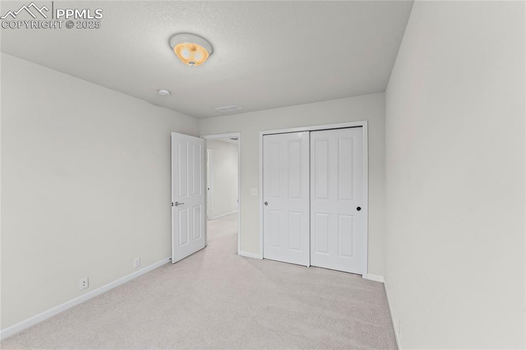 Image 23 of 26: Unfurnished bedroom featuring carpet and a closet