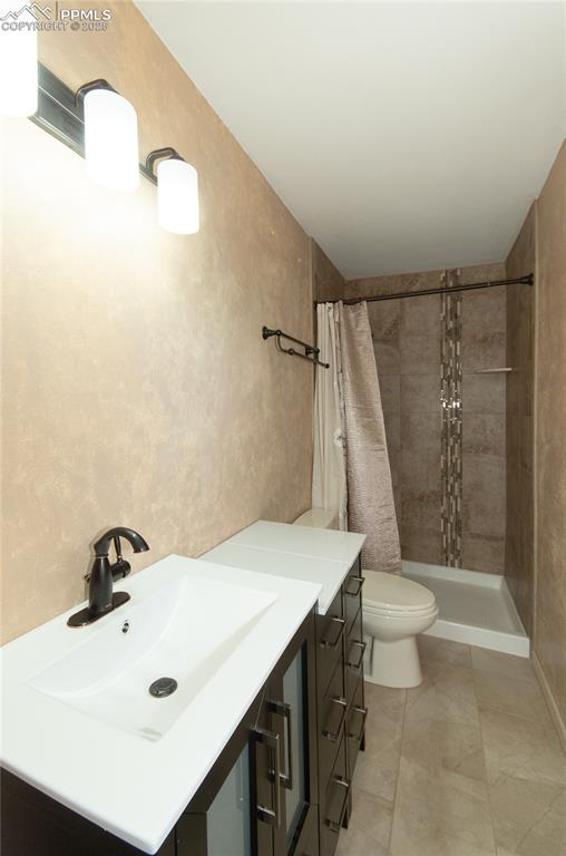 Image 16 of 42: Full bath with vanity and tiled shower
