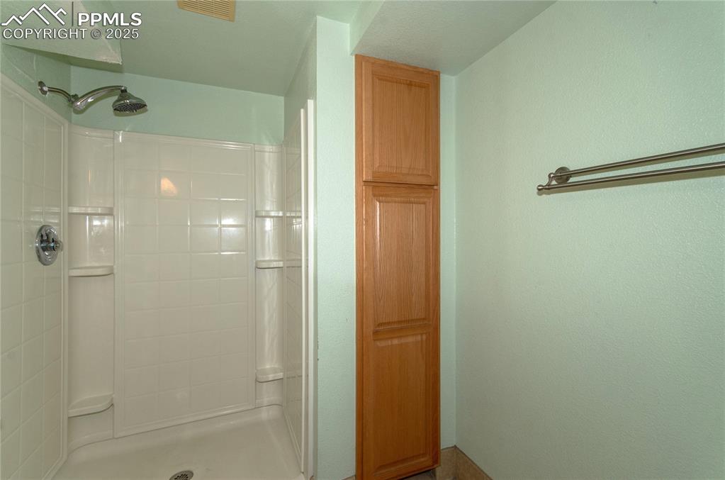 Image 22 of 42: Bathroom featuring a tile shower