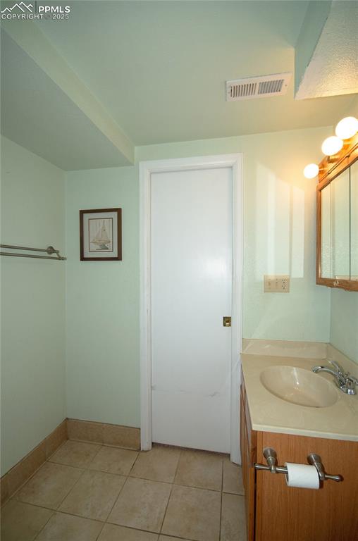 Image 23 of 42: Bathroom featuring vanity and tile patterned floors