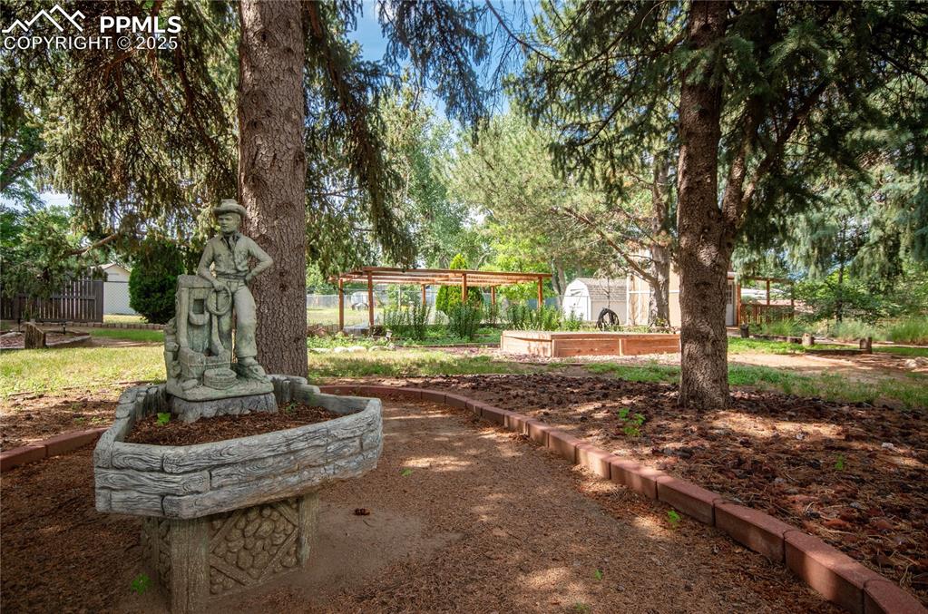 Image 28 of 42: View of yard with a garden
