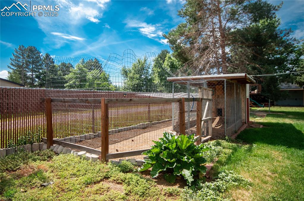 Image 30 of 42: View of green lawn featuring exterior structure and an outbuilding
