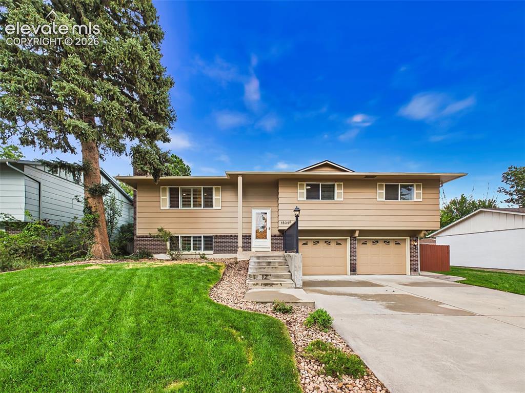 Caption: Front Exterior – Attractive split-level home with fresh exterior appeal, highlighted by new front-ya