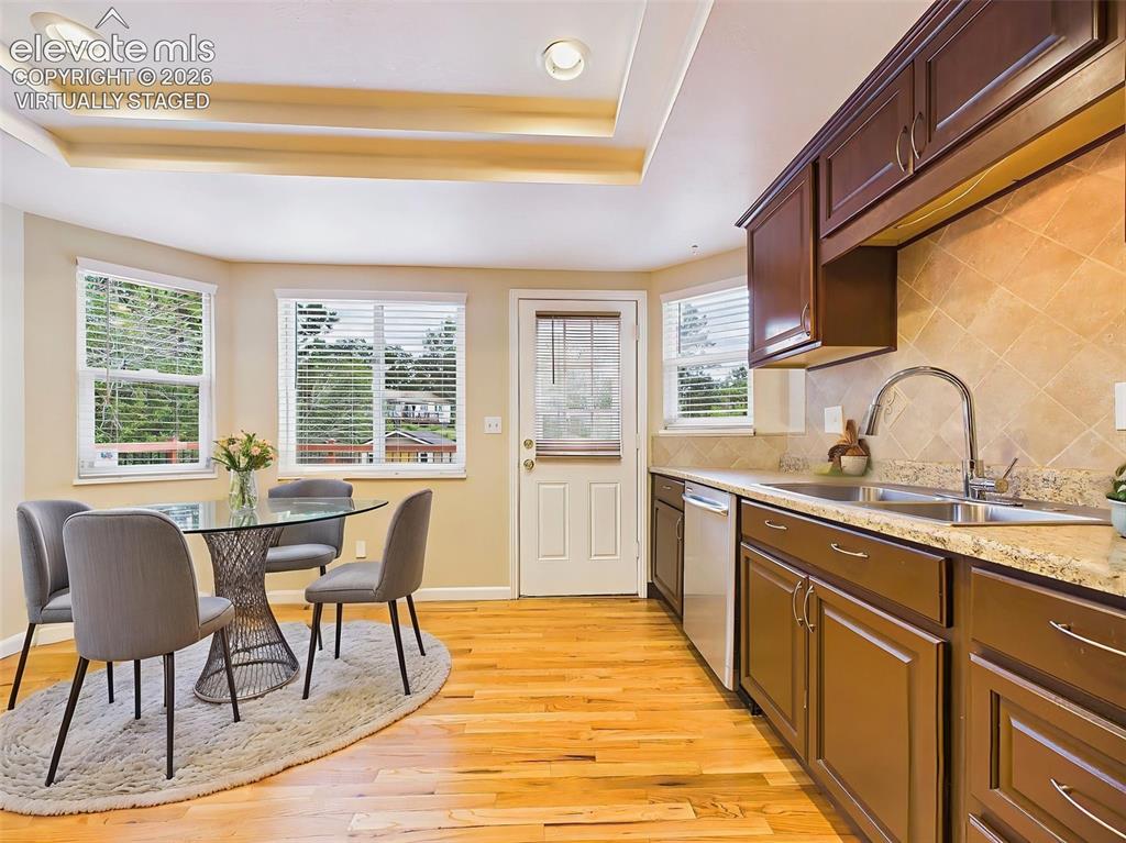 Image 12 of 50: (Virtually Staged) Sunny breakfast nook surrounded by windows with direct a
