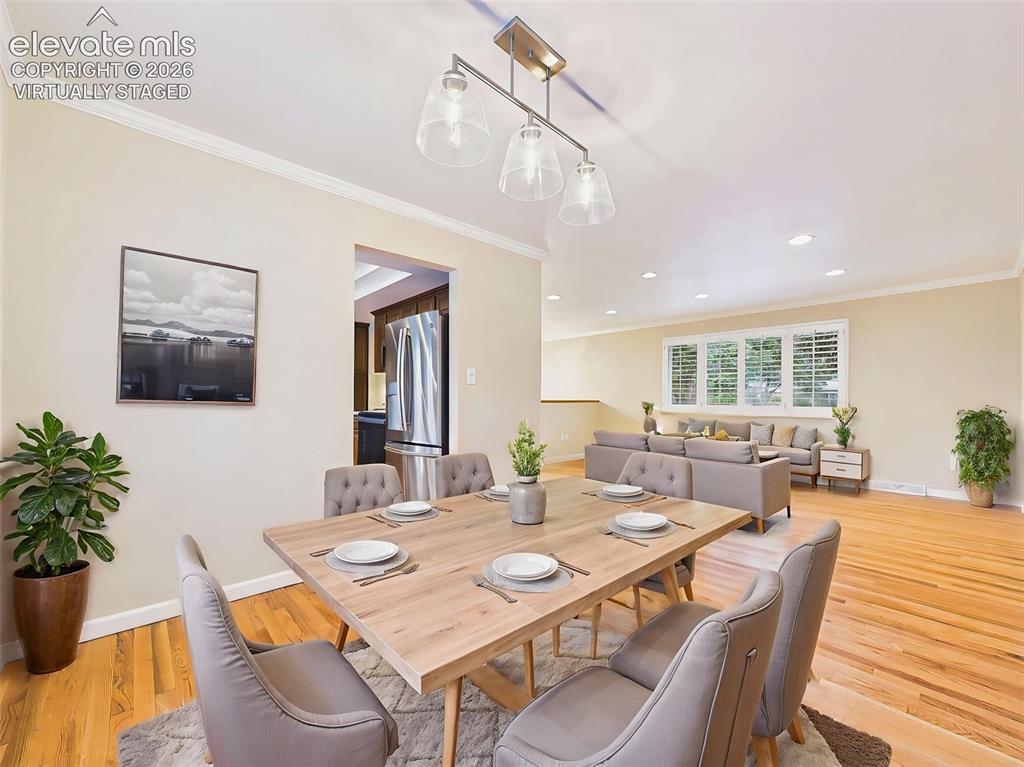 Image 16 of 50: (Virtually Staged) Living & Dining Areas – Expansive living room with hardw