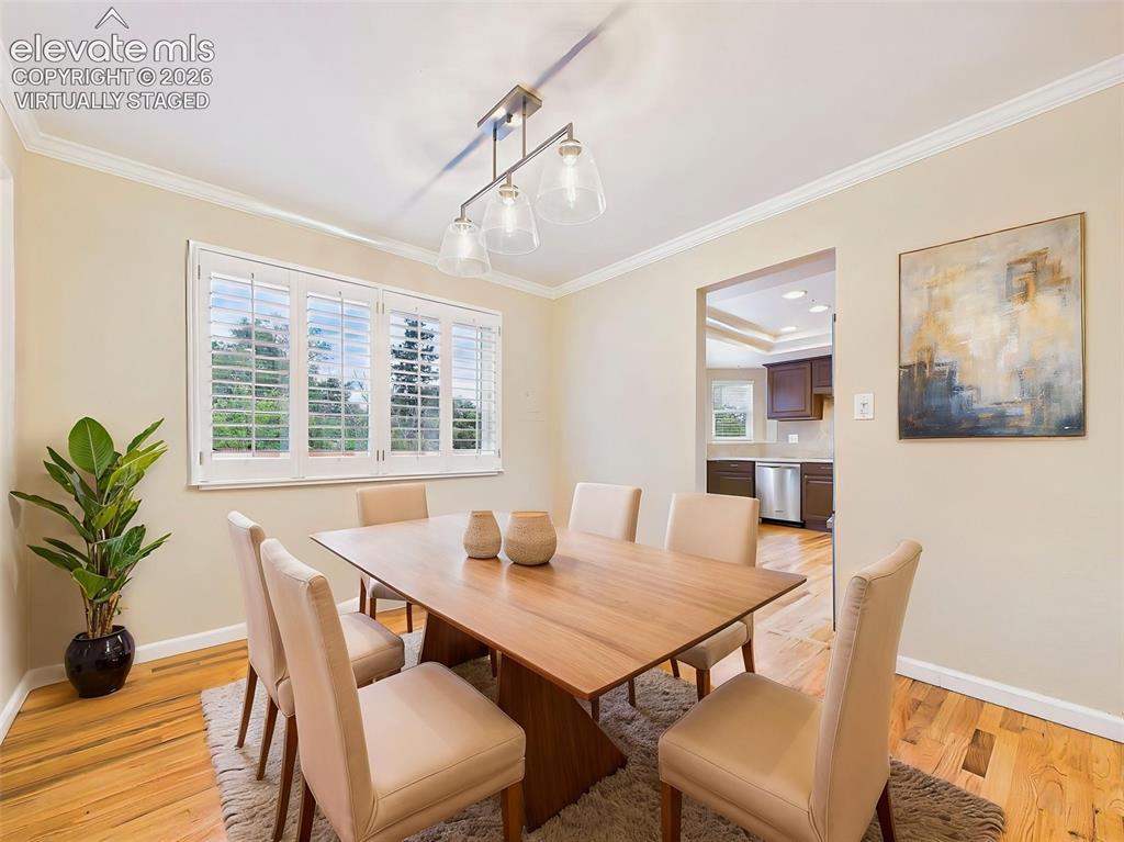 Image 18 of 50: (Virtually Staged) Formal dining room with hardwood flooring, crown molding