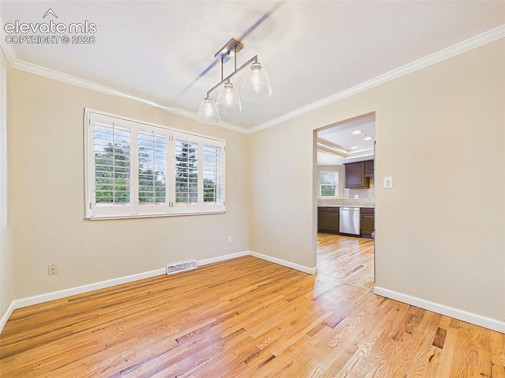 Image 19 of 50: Another view of the dining room highlights its spacious layout, abundant na