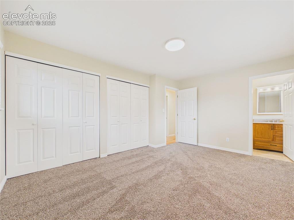 Image 22 of 50: Another view of the generously sized primary bedroom highlights the comfort