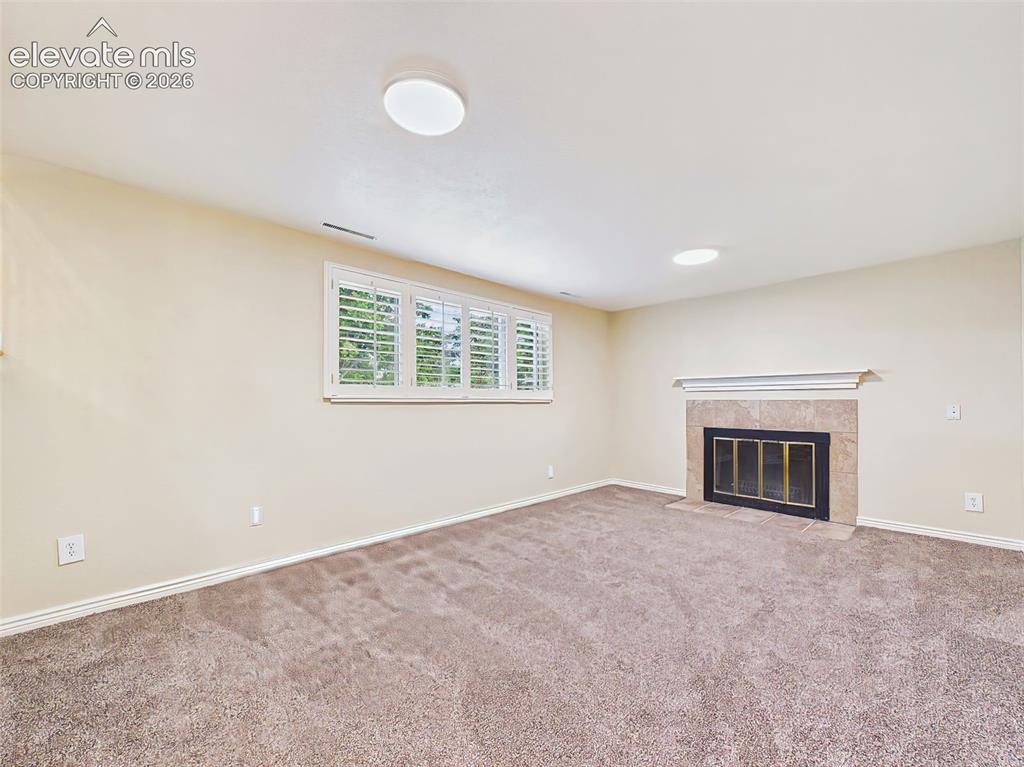 Image 32 of 50: Family Room – Another view highlights the large window with plantation shut
