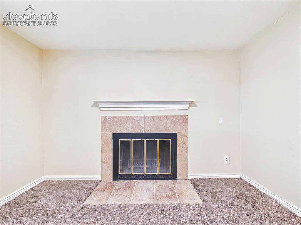Image 33 of 50: Fireplace Detail – Tile-surround fireplace with a classic mantel serves as 