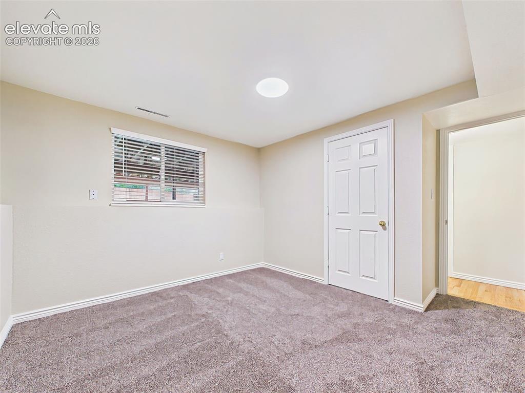 Image 36 of 50: Versatile lower-level bonus room with brand-new carpet and natural light, p