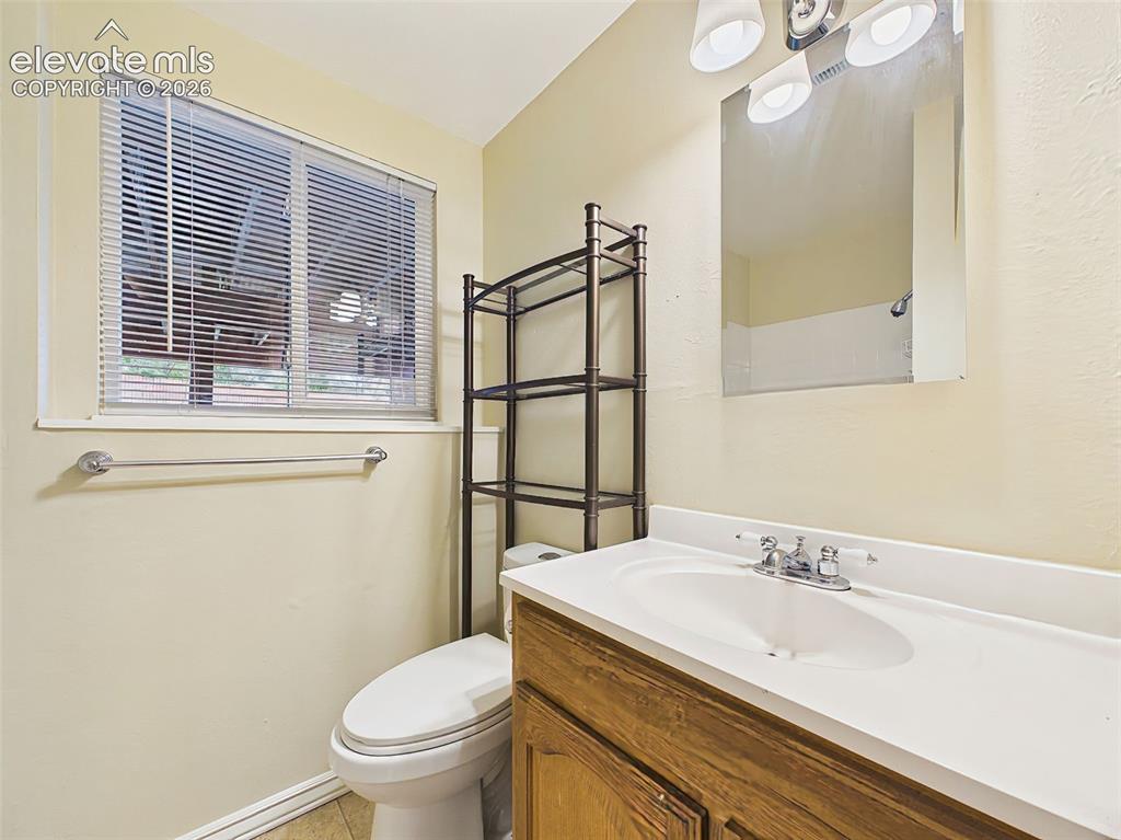 Image 37 of 50: Vanity area offers additional storage, updated lighting, and convenient acc