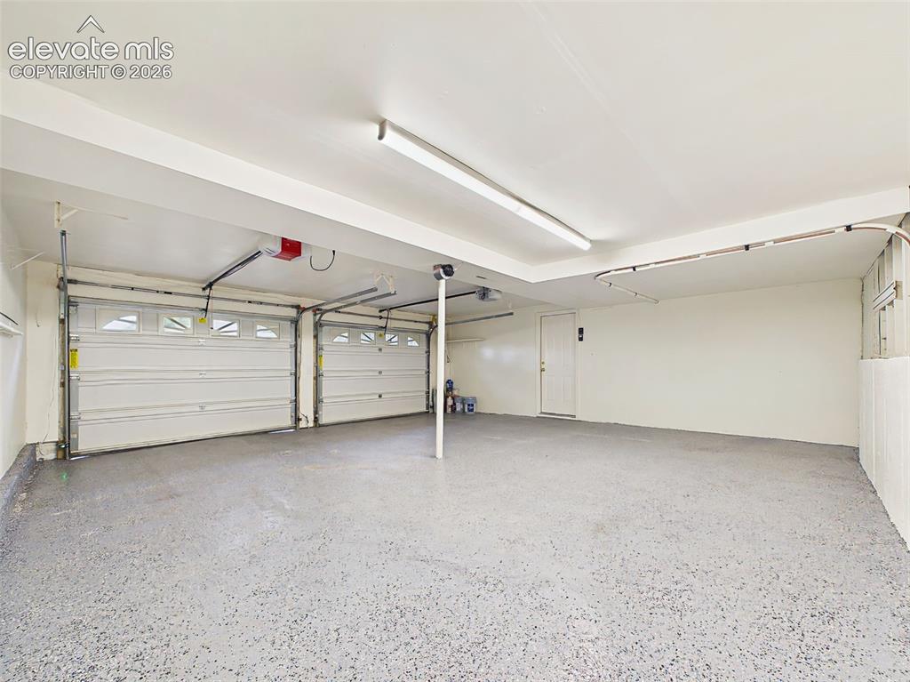 Image 40 of 50: Another view highlights the expansive layout, dual garage doors with automa