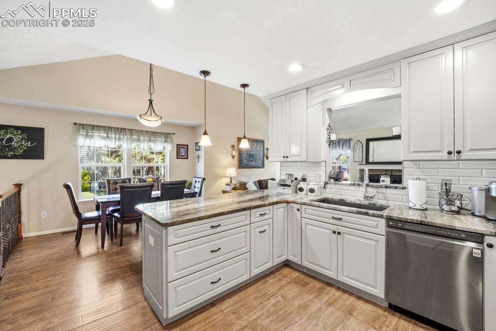 Image 16 of 41: Kitchen featuring light-toned cabinetry, granite countertops, stainless ste