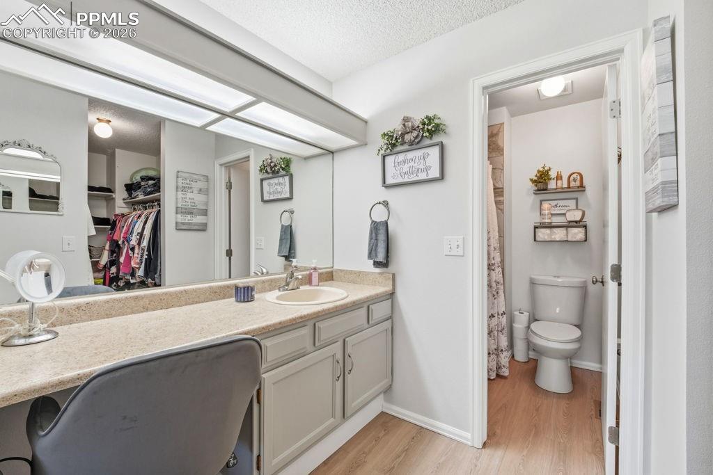 Image 25 of 41: Dressing area featuring an integrated sink, laminate countertop, and full-w
