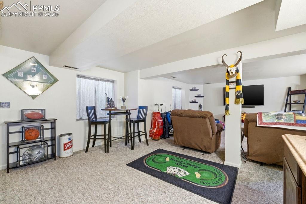 Image 33 of 41: Finished basement area featuring light-toned carpeting and white painted wa
