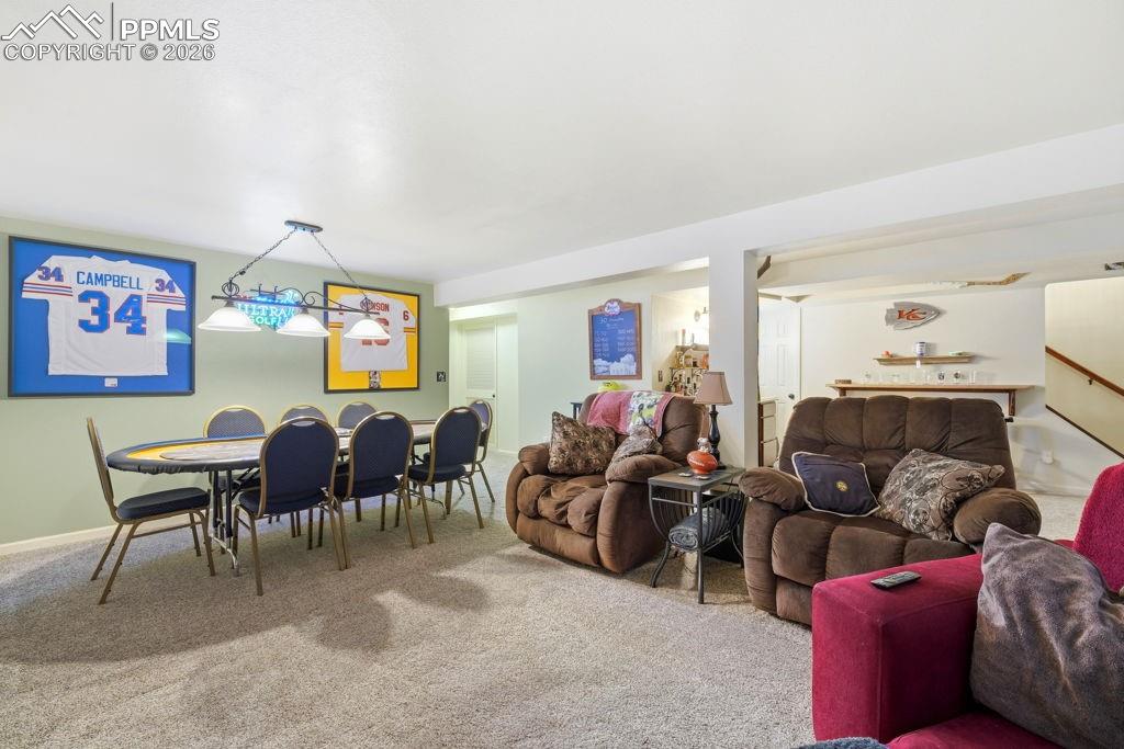Image 35 of 41: Spacious carpeted room featuring a ceiling-mounted light fixture, light gre