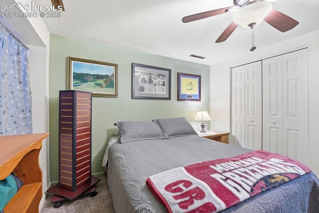 Image 39 of 41: Lower level bedroom with recessed window with blue patterned drapes, ceilin