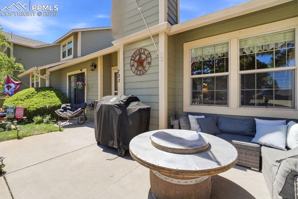 Image 5 of 41: Exterior patio featuring a concrete surface and small lawn